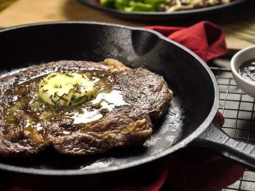 Rosemary Ribeye Steak Recipe- Tender rosemary ribeye steak with a knob of rosemary butter and roasted vegetables.