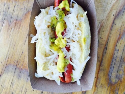 hotdog with sauerkraut in a cardboard box