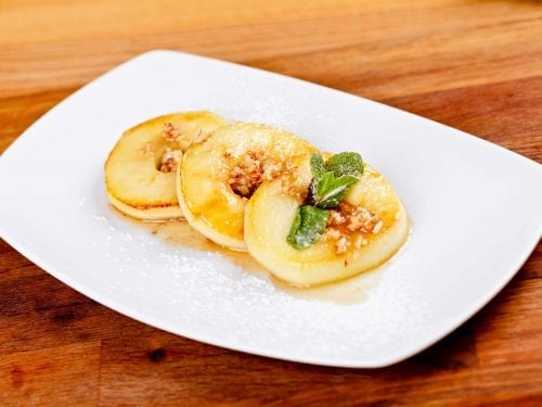 glazed apple rings on a white plate