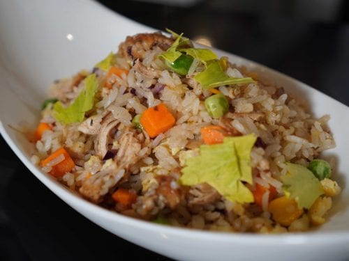 shredded chicken fried rice in a white bowl