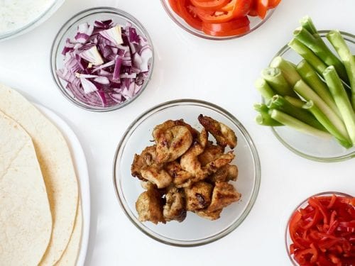 Refried Beans Tostadas with Creamy Salsa - Refried beans and bite-size chicken strips on top of a crunchy Mexican tostadas with creamy salsa and sour cream sprinkled with cheese, crunchy vegetables, and other toppings