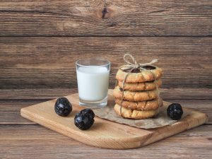 Spice Date Cookies Recipe, cookies with date nuts, cinnamon, and cinnamon, stack of date cookies on wooden table with glass of milk