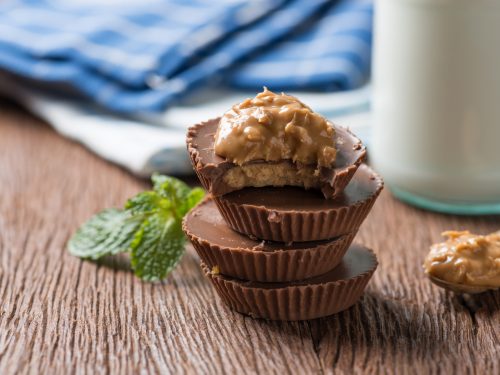 homemade peanut butter cup, stack of dark chocolate with milk bottle, dessert food.