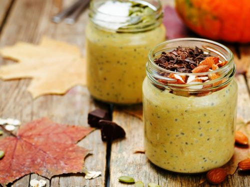 Jar filled with pumpkin-flavored overnight oats and chia seeds.