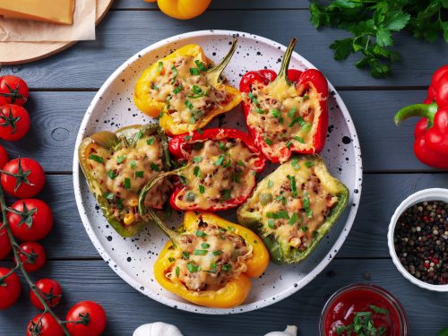 tasty stuffed bell peppers on wooden table