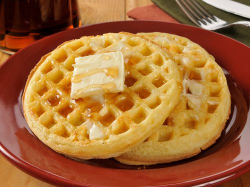 eggo waffles with butter and maple syrup on a plate