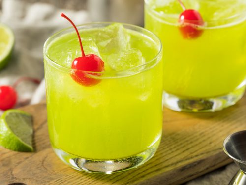 Midori Sour Recipe, Midori sour served in a glass with a cherry on top