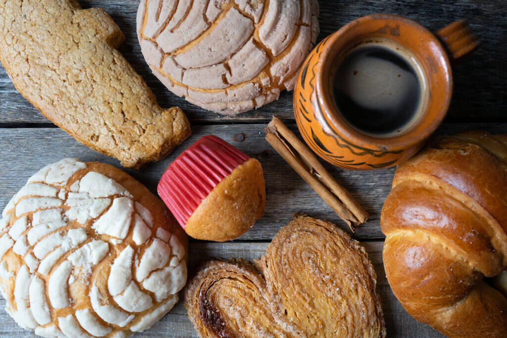 mexican desserts, mexican sweet bread and coffee on a table