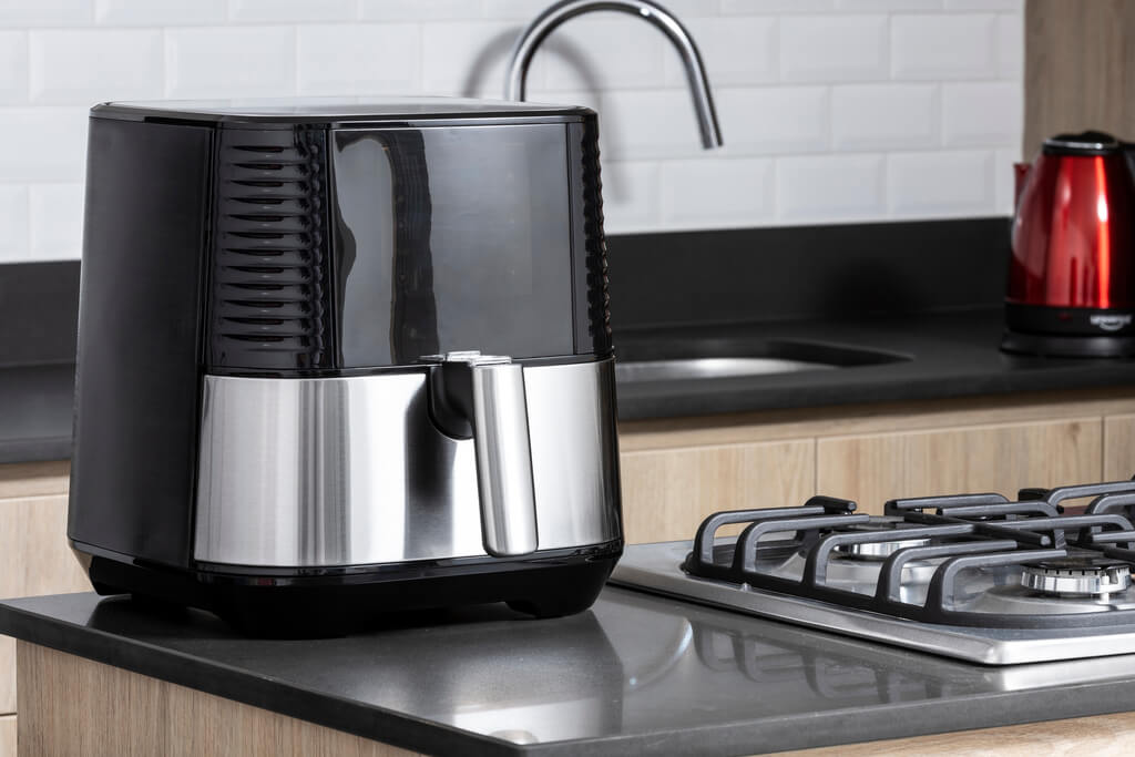 black air fryer on kitchen countertop