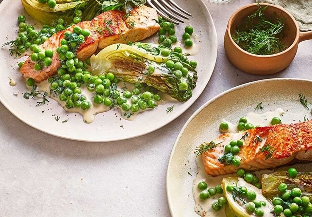 Stir fry of green peas with grilled salmon