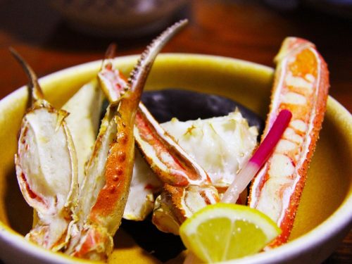 close-up shot of grilled crab legs with lemon