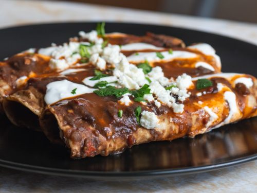 Enfrijoladas Recipe, mexican enfrijoladas with black bean sauce, mexican crema, and queso fresco