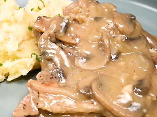 smothered pork chops in an amazing mushroom gravy recipe